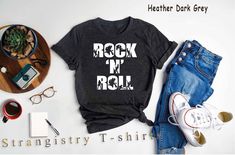 "Rock n Roll Music Band Shirt. Rock Music Concert Shirt. Music Teacher Shirt. Rock and Roll Shirt. Rock Music Lover Gift. Rock Music Player Gift... Check Out for Other Rock Music Shirts  https://www.etsy.com/shop/StrangistryTshirts?search_query=rock ----- How To Order ----- 1-) Please, check and review all the photos. 2-) Choose your t-shirt size and color. *Different styles of shirts may have different shades of same color choice due to different manufacturer brands. *For this reason, we recommend you to match shirts from the same styles if you want precisely matching colors (ex. Unisex, V-necks, Toddler, etc.). 3-) Click add to cart. You can go back to add more shirts. 4-)Click \"Proceed to check out\". 5-)When you check out, you can add a note to seller for any request. ----- Unisex Shi Rock Style Band Logo T-shirt For Summer, Cotton Rocker Top With Graphic Design, Rocker Cotton Shirt With Graphic Print, Cotton Rocker Shirt With Graphic Print, Rocker Style Relaxed Fit T-shirt With Letter Print, Rock Style Screen Print Shirt For Concert, Rock And Roll Cotton Shirt For Concert, Rock Style Graphic Print Shirt For Concert, Letter Print Rock And Roll Tops For Concert