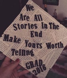 someone holding up a graduation cap that reads we are all stories in the end make yours worth