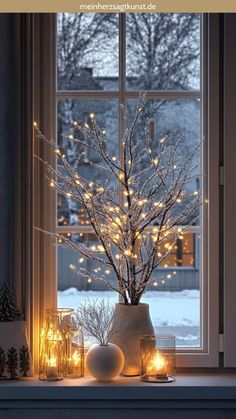 a window sill filled with christmas lights next to a potted plant and candles