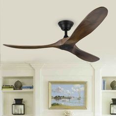 a ceiling fan mounted to the side of a wall in a room with bookshelves