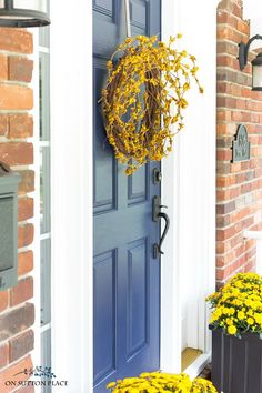 the front door is decorated with yellow flowers