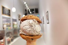 an ice cream sundae is being held up