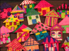 many different colored houses are shown on the table, and one is made out of paper