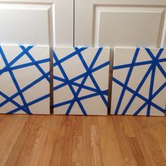 three white and blue boxes sitting on top of a wooden floor