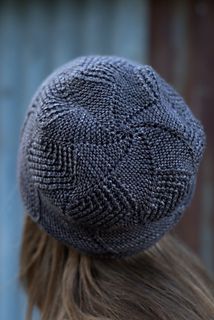 a woman wearing a gray knitted hat