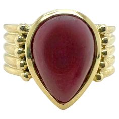 This stunning ring features a lustrous pear-shaped ruby cabochon, known for its deep, rich red color and smooth, rounded surface. Set in a striking 14K gold band with a ribbed texture, the ring combines classic elegance with modern flair. The ribbed band provides a bold contrast to the velvety ruby, creating a unique and sophisticated piece that stands out with its timeless charm. Sophia D has been known world-wide for over 40 years because of its rich history of design and quality craftsmanship Pear Cabochon Ring, Ruby Cabochon Ring, Yellow Gold Amethyst Ring, Most Popular Engagement Rings, Gold Amethyst Ring, Ruby Ring Gold, Trending Engagement Rings, Ring Trends, Cabochon Ring