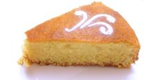 a piece of yellow cake with white icing on it's top and bottom