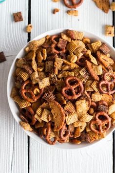 a white bowl filled with cheetos and pretzels