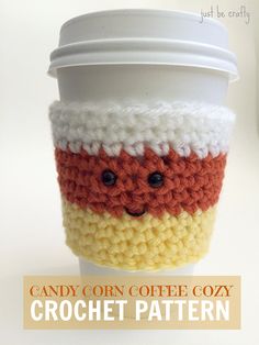 a coffee cup with a crochet pattern on it and the words candy corn coffee cozy written below