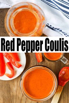 two jars filled with red pepper sauce on top of a wooden table next to spoons