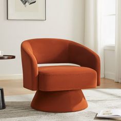 an orange chair sitting on top of a white rug