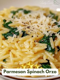 pasta with spinach and parmesan cheese in a white bowl