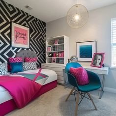 a bedroom decorated in black, white and pink with a chevron pattern on the wall