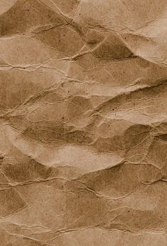 an old brown paper textured with small waves and lines on the bottom half of it