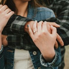 a couple holding hands while standing next to each other