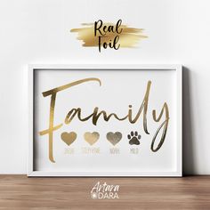 a family print with hearts and paw prints in gold foil on a white wall above a wooden shelf