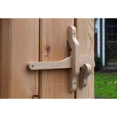 a wooden door handle on the side of a house