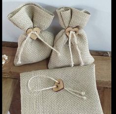 three burlap bags tied together with wooden buttons