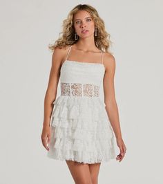 Showcase your eye-catching beauty in the Rochelle formal mini dress, a gorgeous staple for brides-to-be! Crafted with airy sheer lace fabric with a partial knit lining, she brings that effortlessly chic allure and feminine charm. She features a sleeveless cowl neckline with pleated detailing and a built-in padded bust, adjustable spaghetti straps that lead to an open cross-back design, a stunning sheer corset-inspired waist with flexible boning for structure, and a tiered ruffled A-line silhouet Lace Trim Mini Dress For Homecoming, Elegant Mini Dress With Lace Trim, Glamorous Lace Mini Dress, Homecoming Mini Dress With Lace Trim, Summer Homecoming Dresses With Lace Trim, Lace Mini Dress For Homecoming, Glamorous Mini Dress With Lace Trim, Fitted Lace Trim Mini Dress For Homecoming, Elegant Lace Trim Mini Dress For Homecoming