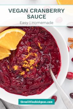 vegan cranberry sauce in a white bowl with orange wedges on the side