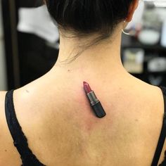 a woman with a red lipstick tattoo on her back