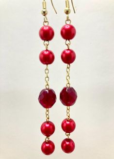 Ruby Red Pearl Bead Acrylic Bead Dangle Drop Earrings w Gold Tone Accents. 3.50 in. drop. Red Beaded Earrings For Holiday With Round Beads, Red Beaded Earrings For Holiday, Red Long Drop Beaded Earrings As Gift, Red Long Drop Beaded Earrings For Gift, Red Chandelier Earrings With Dangling Beads As Gift, Gift Red Chandelier Earrings With Dangling Beads, Party Large Beaded Drop Earrings, Red Round Beads Chandelier Earrings Gift, Red Dangle Beaded Earrings For Party