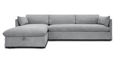 a gray couch with a footstool sitting on top of it's side