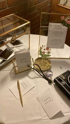 a table topped with lots of different items on top of a white cloth covered table