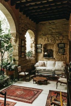 a living room filled with lots of furniture and rugs on top of a floor