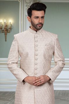 This mens sherwani, style number M42-S143, features a classic design with intricate thread embroidery. This traditional embroidery adds a touch of elegance to the garment, making it perfect for special occasions. The embroidery is done with precision and care, ensuring a high-quality finish for a sophisticated look. Mens Sherwani, Traditional Embroidery, Sophisticated Look, Thread Embroidery, Sherwani, Classic Design, Light Grey, Thread, Embroidery