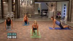 a group of people doing push ups in a room with other people on the floor