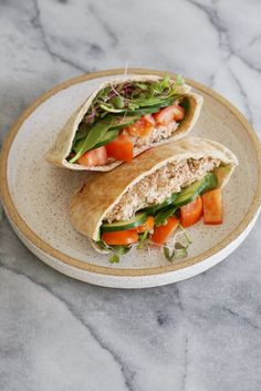 two wraps filled with meat and vegetables on a plate