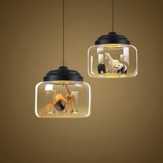 two hanging lights with animals inside them