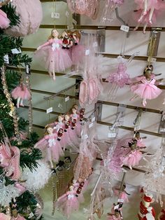 many pink and white ornaments are hanging on the wall