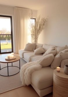 a living room filled with furniture next to a large open window and a white couch