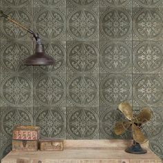 a wooden table topped with a fan next to a wall mounted lamp and other items