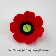 a red flower with a green button on it