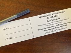 a ticket for a youth league fundraiser sits on a table next to a fountain pen