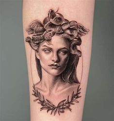 a woman's face with snakes on her head and leaves around her neck tattoo