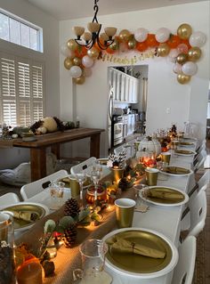 a long table is set with plates and glasses for an elegant holiday dinner or party