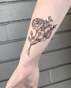 a person's hand with a flower tattoo on the left wrist and an armband