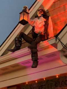 a statue of a man sitting on top of a building next to a street light