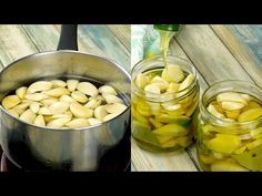 jars filled with pickles sitting on top of a wooden table