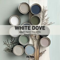 the words white dove are painted on top of some paint cans with flowers in them