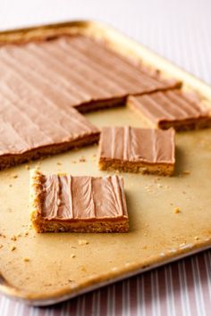 there are pieces of cake that have been cut in half on a baking sheet,