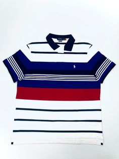 An American style standard since 1972, the Polo shirt has been imitated but never matched. Over the decades, Ralph Lauren has reimagined his signature style in a wide array of colors and fits, yet all retain the quality and attention to detail of the iconic original. This classic fit version features a signature embroidered Big Pony and an American flag shield patch at the chest.   DETAILS Cut for a lower armhole and a fuller sleeve that falls closer to the elbow. Two-button placket. Tennis tail Casual Collared T-shirt With Contrast Stripes, White Collared Shirt With Contrast Stripes, Casual Short Sleeve Tops With Signature Stripes, White Polo Shirt With Striped Collar, White Shirt With Striped Polo Collar, Casual Blue T-shirt With Striped Collar, Classic White Tops With Contrast Stripes, Navy Fitted Top With Contrast Stripes, Casual Multicolor Polo Shirt With Striped Collar