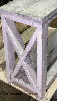 a white wooden table sitting on top of a piece of wood