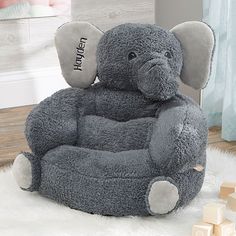 an elephant shaped chair sitting on top of a white rug