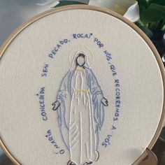 a cross stitched image of the virgin mary