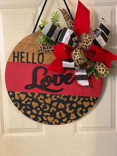 a door hanger with a leopard print and red ribbon